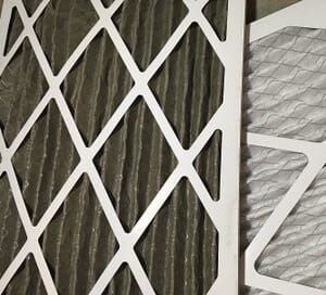 a dirty air filter next to a clean one