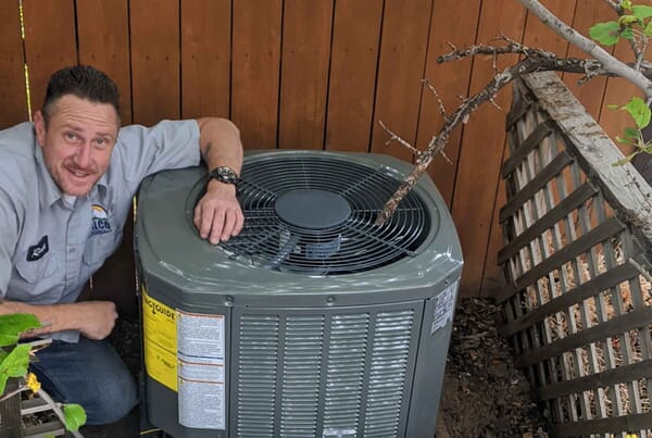 DALCO AC technician installing Trane air conditioner at a Denver home